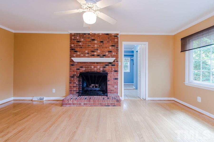 2705 Wycliff Road Raleigh, NC 27607 - Photo 8 of 22 an empty room with windows and fireplace