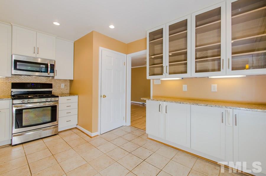 2705 Wycliff Road Raleigh, NC 27607 - Photo 9 of 22 a kitchen with stainless steel appliances granite countertop a stove and a refrigerator