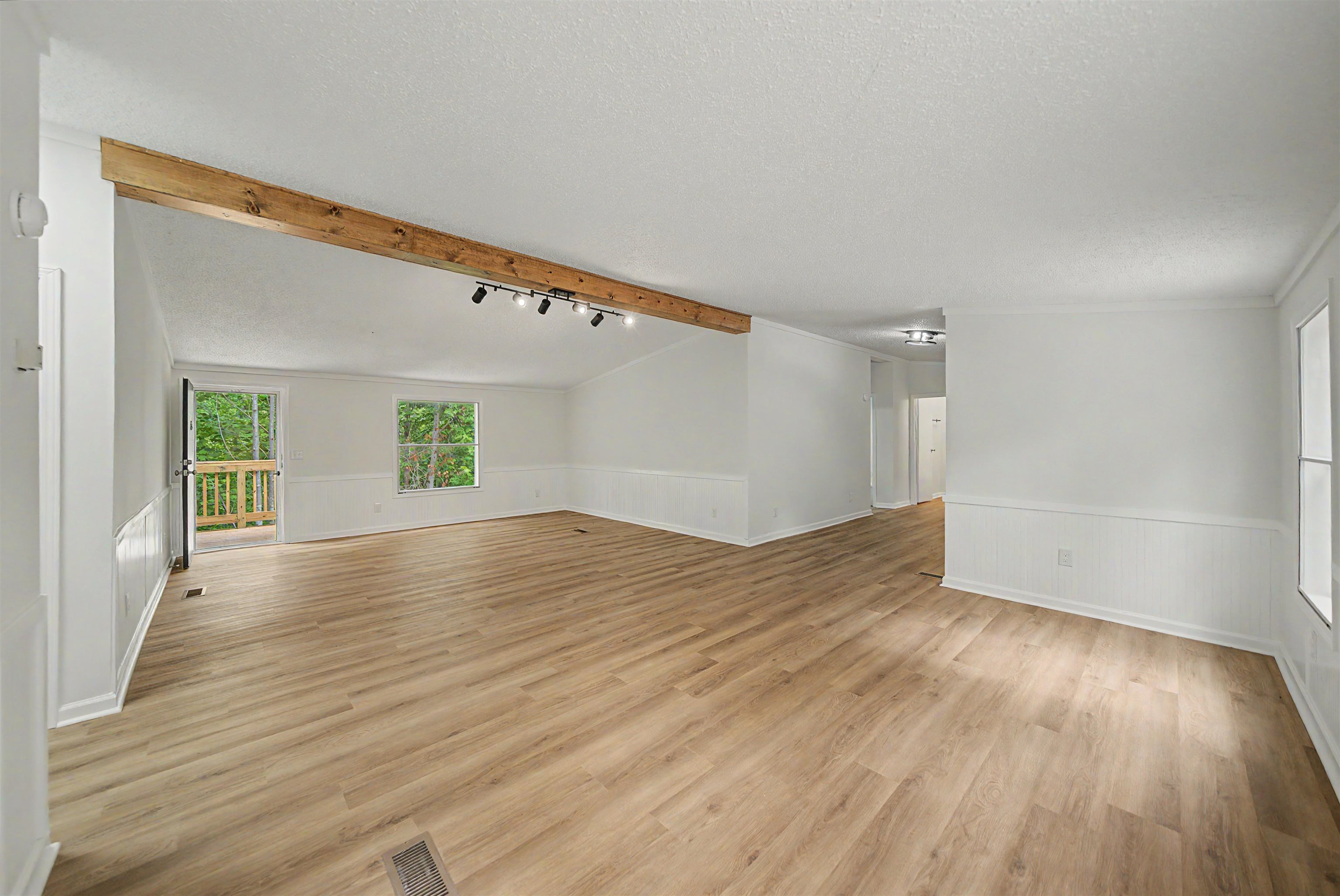 890 Burks Road Savannah, TN 38372 - Photo 4 of 40 an empty room with wooden floor and windows