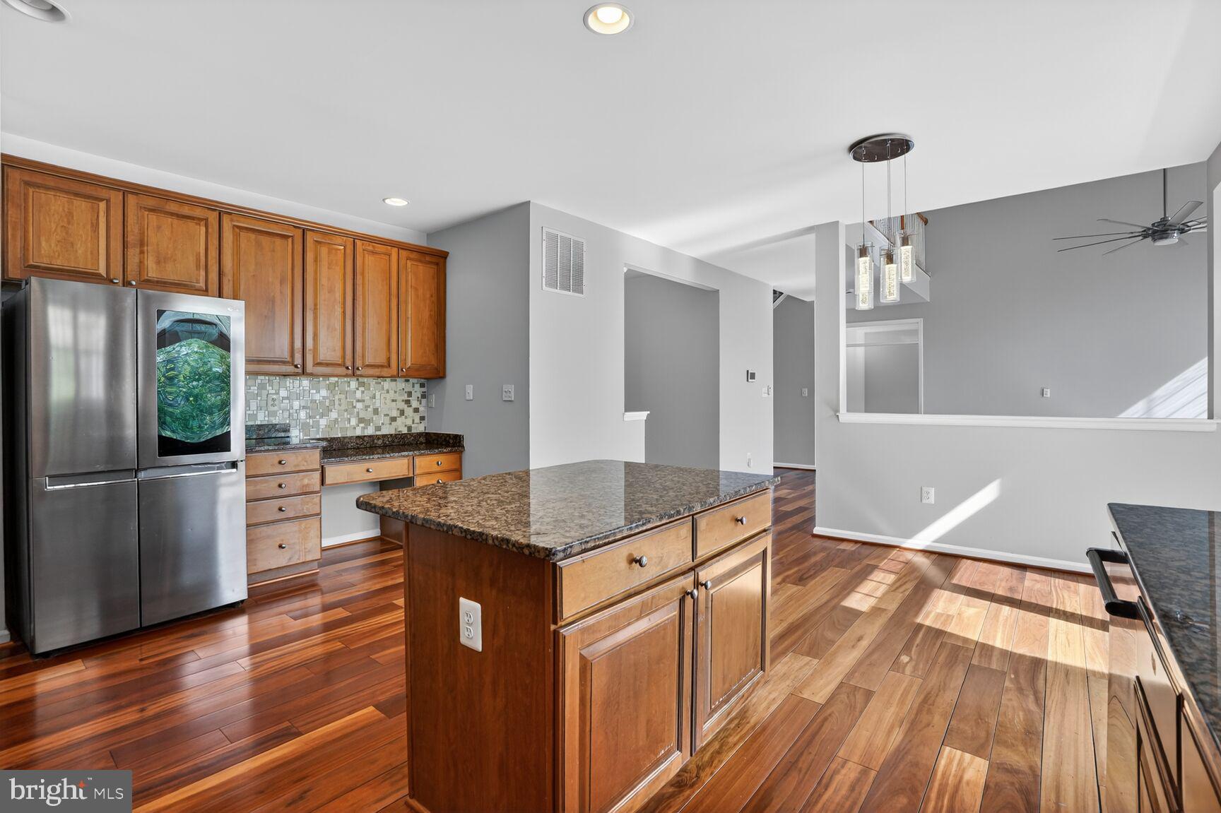 25845 Spring Farm Circle Chantilly, VA 20152 - Photo 12 of 57 Modern kitchen with rich wood accents.