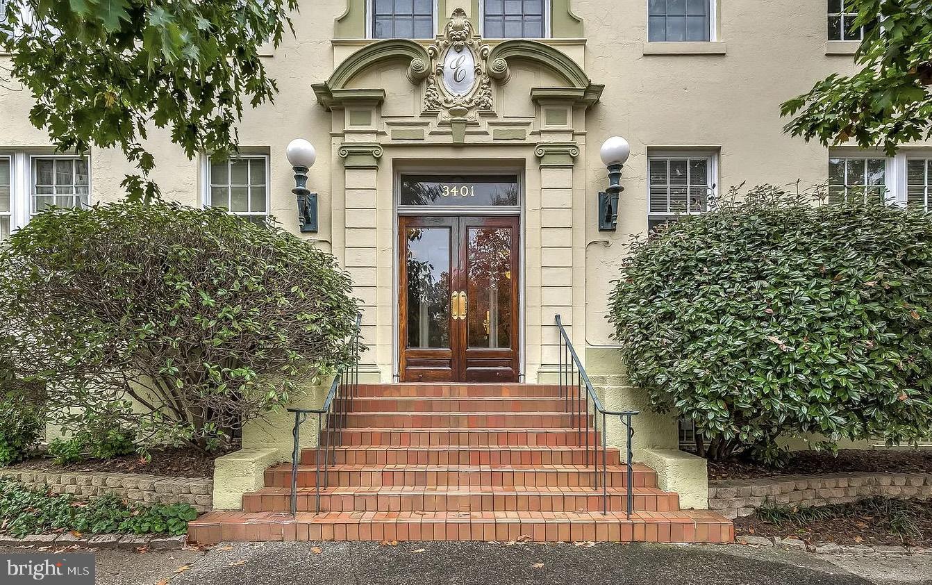 a front view of a house with plants