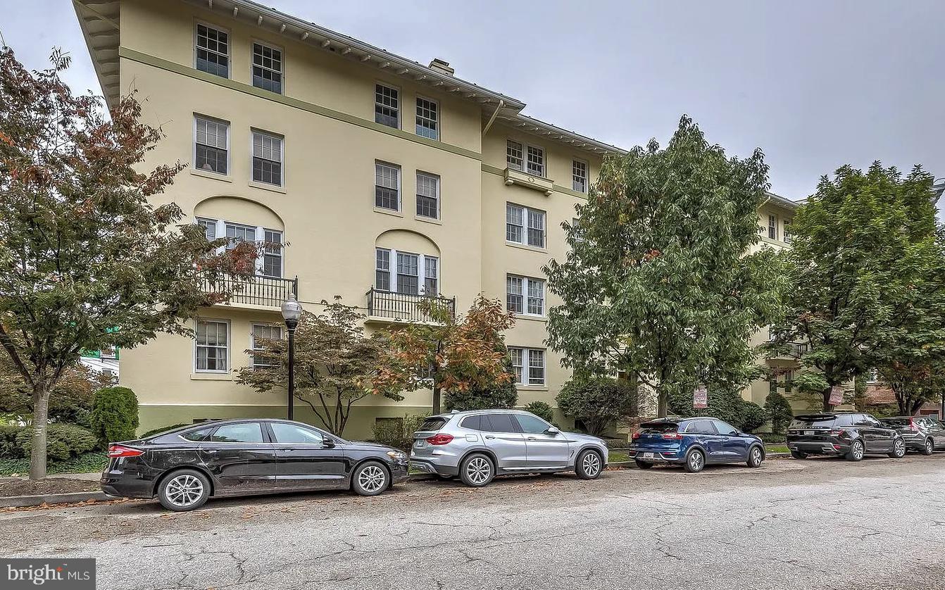 3401 Greenway, Unit 50 Baltimore, MD 21218 - Photo 12 of 12 a front view of a house with cars parked on the roadside