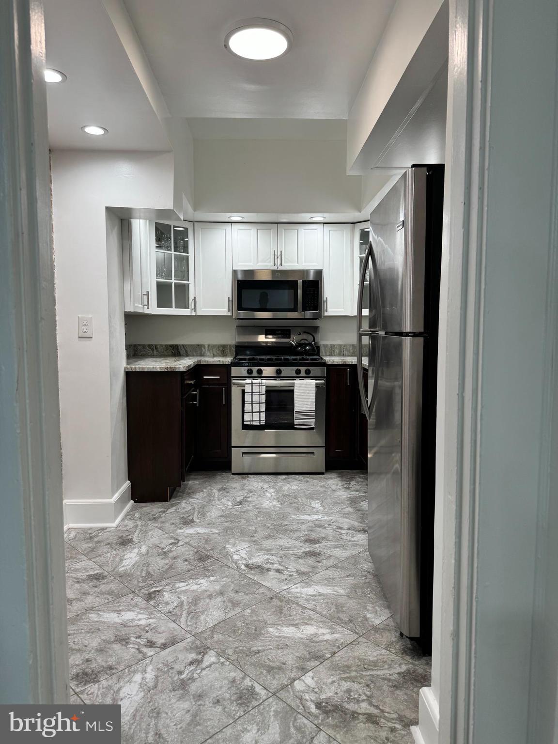 3401 Greenway, Unit 50 Baltimore, MD 21218 - Photo 6 of 12 a kitchen with stainless steel appliances granite countertop a refrigerator and a stove