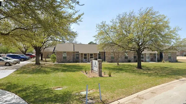 a house with huge green field and trees