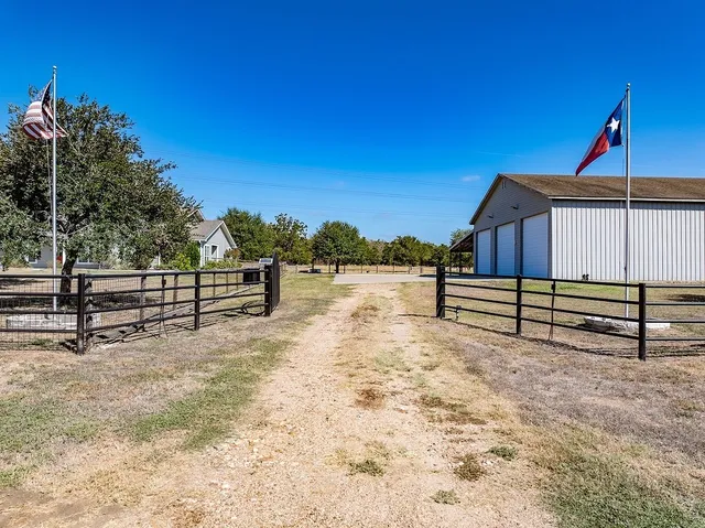 a view of backyard with wooden fence
