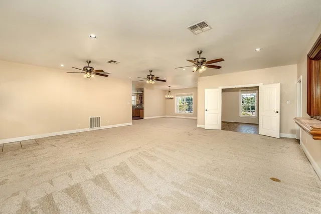 a bathroom with a granite countertop sink a toilet a mirror and shower