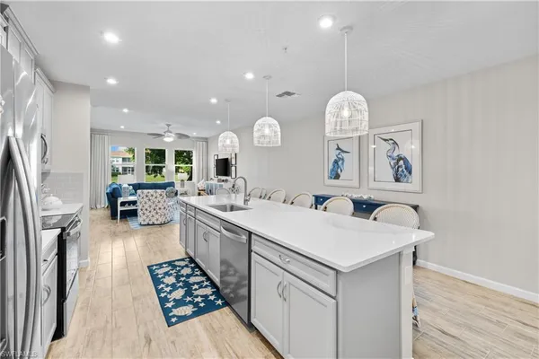 a kitchen with a sink a stove top oven and refrigerator
