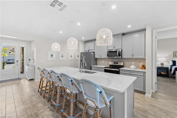 a kitchen with sink cabinets and wooden floor