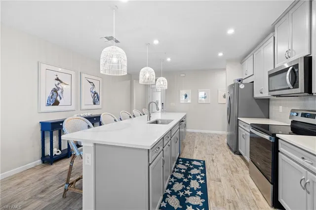 a kitchen with sink cabinets and stainless steel appliances