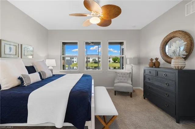 a living room with furniture chandelier and a mirror