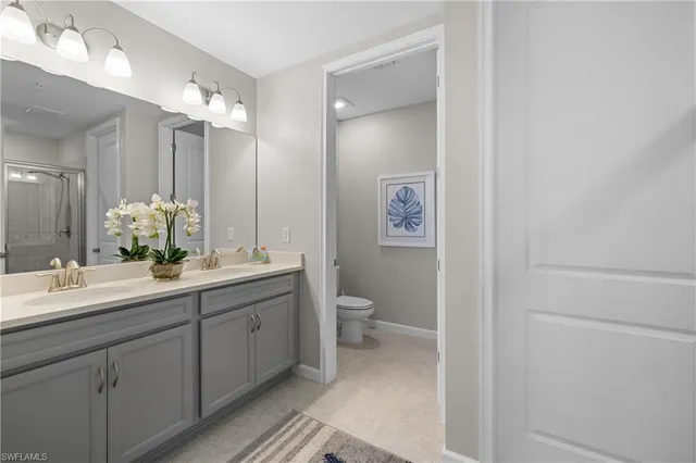 a bathroom with a double vanity sink and a mirror