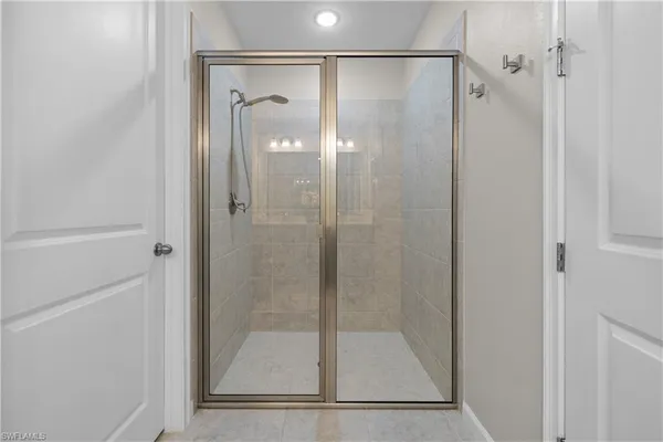 a bathroom with a glass shower door