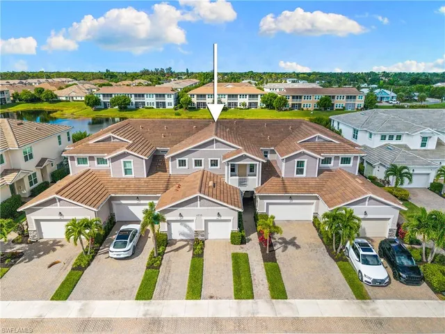 an aerial view of residential houses with outdoor space and ocean view