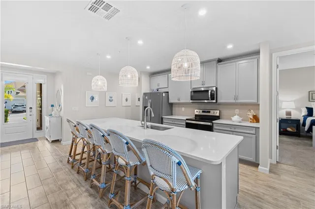 a kitchen with sink cabinets and wooden floor