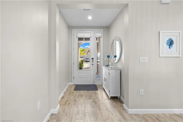 a view of a hallway view with wooden floor and staircase