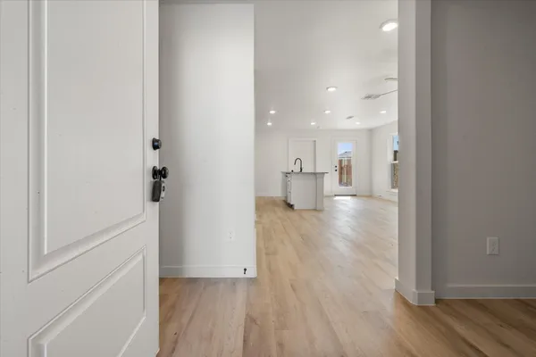 a view of empty room with wooden floor