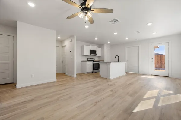 a view of a kitchen with a sink and a refrigerator