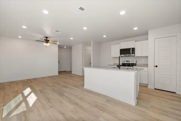 a view of kitchen with microwave and cabinets