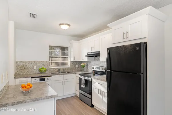 a kitchen with stainless steel appliances a refrigerator sink and stove