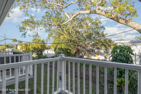 a view of a balcony with flower plants