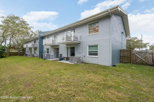 a view of a house with a yard and sitting area