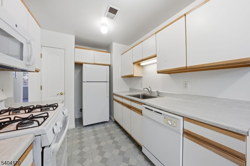 403 Union Street Boonton, NJ 07005 - Photo 7 of 24 a kitchen with stainless steel appliances a sink stove and refrigerator