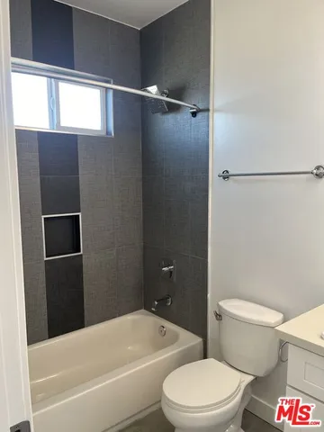 a bathroom with a toilet and a bathtub