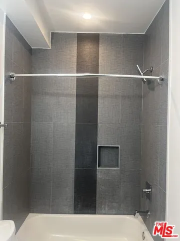 a bathroom with a shower and a toilet