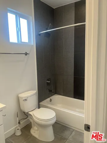 a bathroom with a toilet and a bathtub