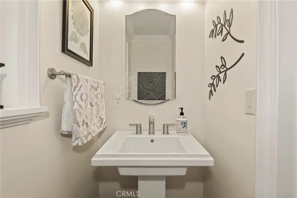 a bathroom with a sink mirror and tub