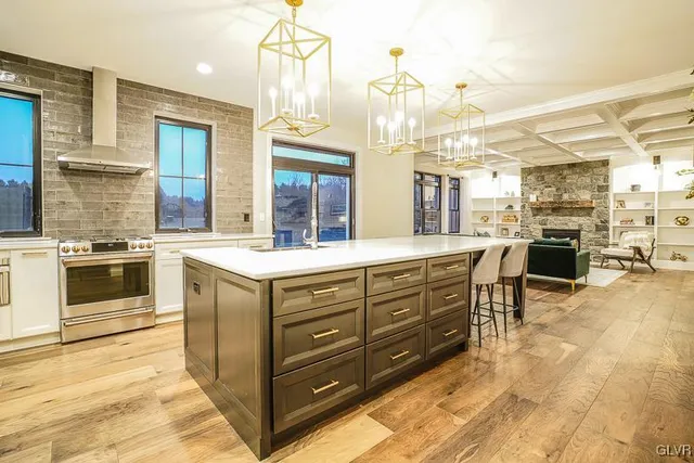 a large kitchen with stainless steel appliances and stove top oven