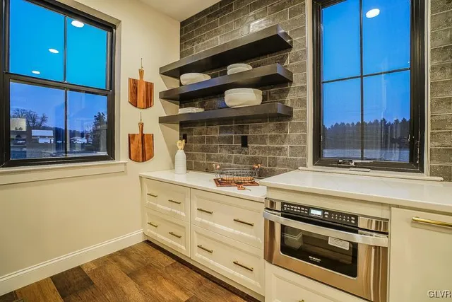 a kitchen with granite countertop white cabinets and white appliances