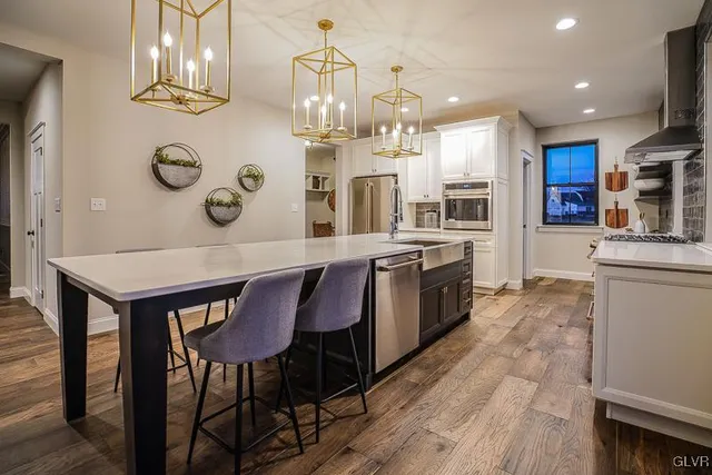 a large kitchen with a table and chairs