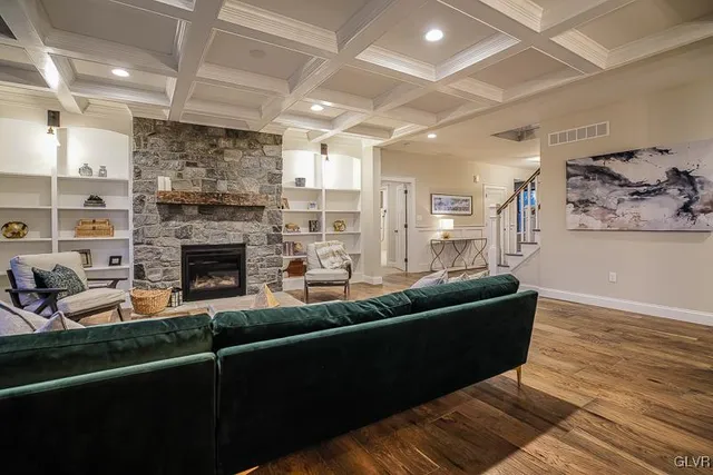 a living room with furniture a fireplace and a flat screen tv