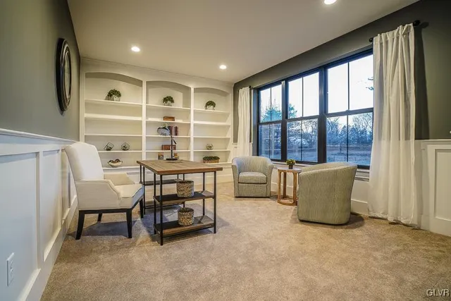 a dining room with furniture and a window