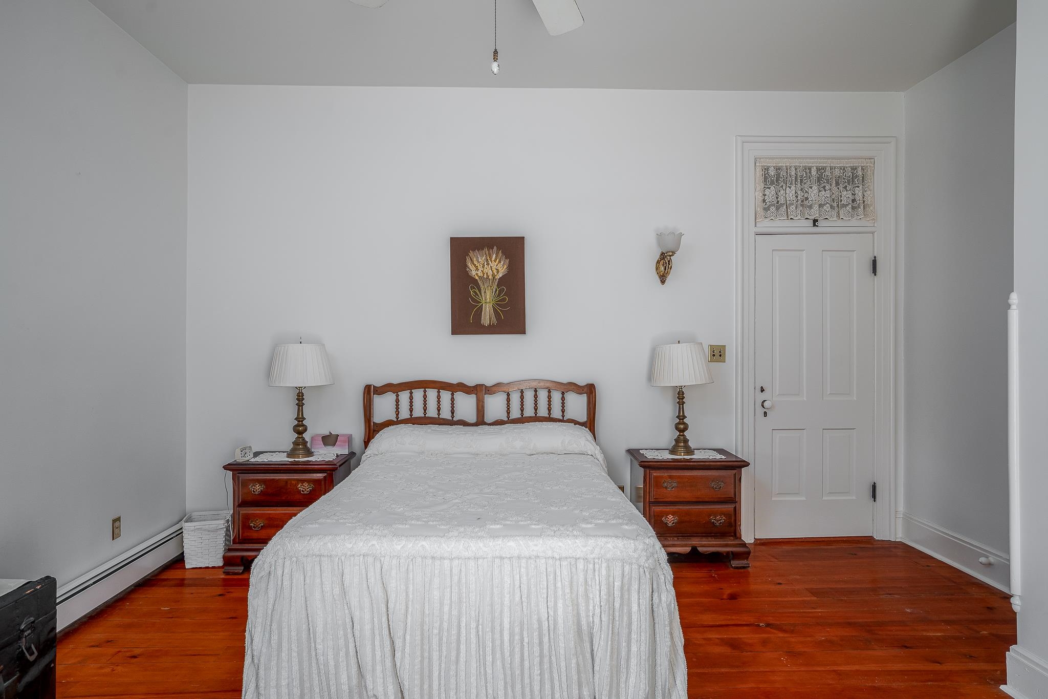 704 River Street Sabula, IA 52070 - Photo 13 of 33 a bed room with a bed and a lamp