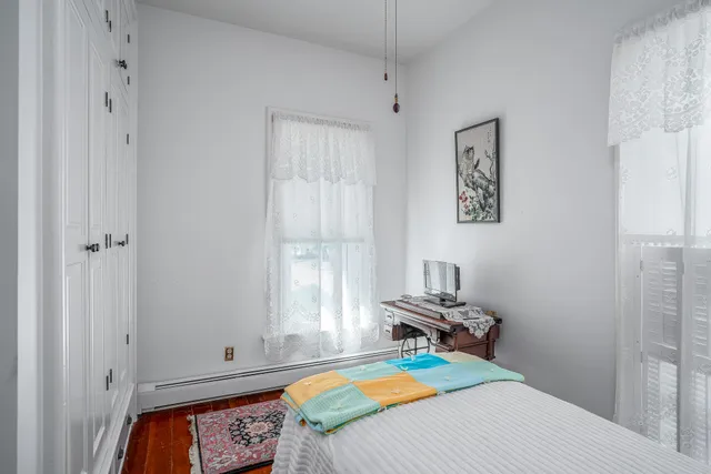 a bedroom with a bed and a rug