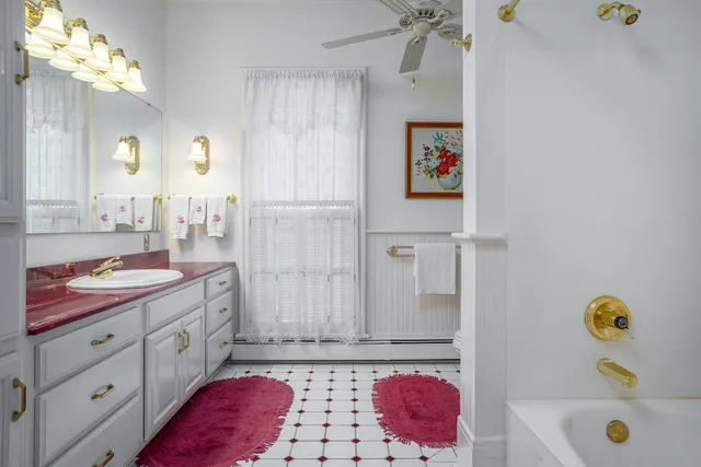 a bathroom with a sink vanity and mirror