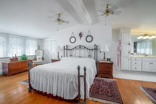 a bedroom with a bed and a chandelier