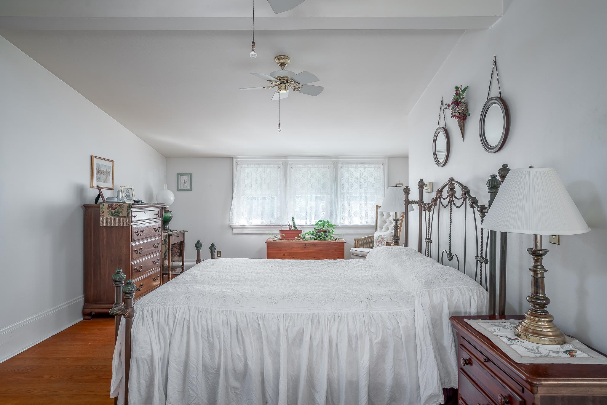 704 River Street Sabula, IA 52070 - Photo 19 of 33 a bedroom with a bed and a chandelier