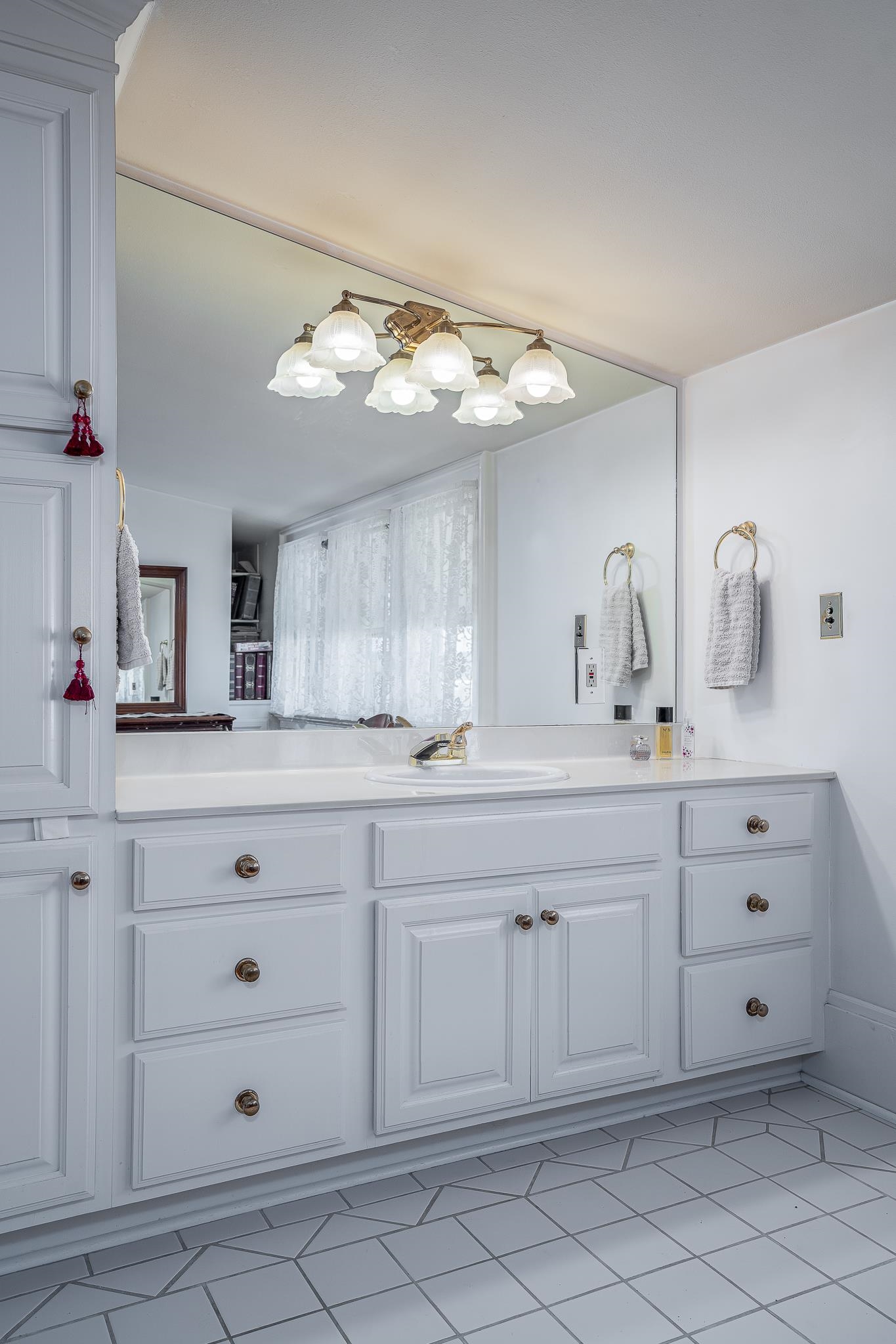 704 River Street Sabula, IA 52070 - Photo 20 of 33 a bathroom with a sink vanity and mirror