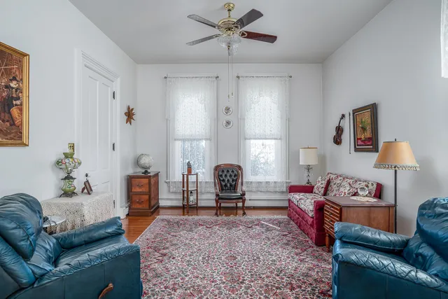 a living room with furniture and a book shelf