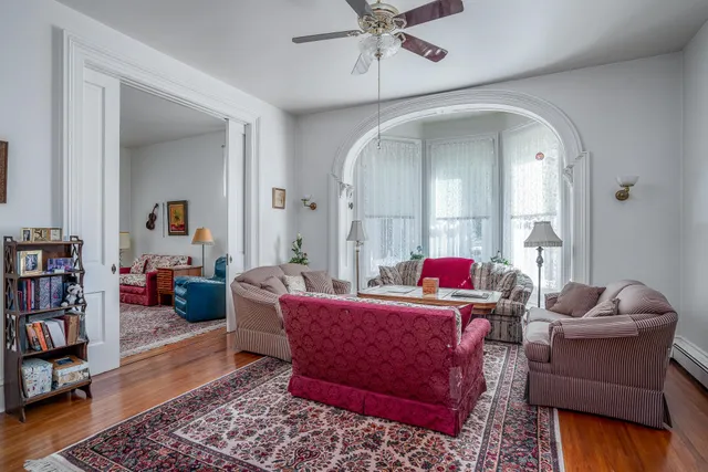 a view of a dining room with furniture and chandelier