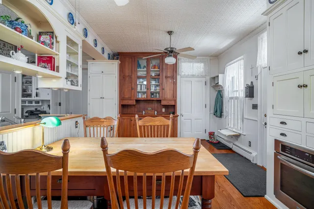 a kitchen with granite countertop a stove a sink and cabinets