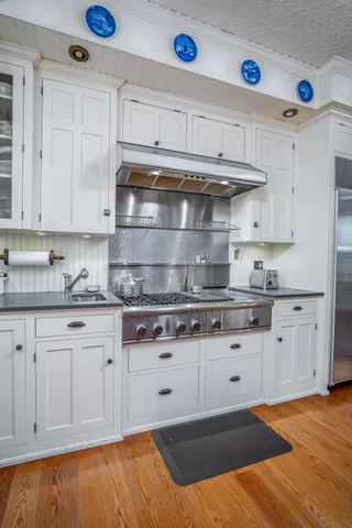 a kitchen with stainless steel appliances granite countertop a refrigerator and a sink