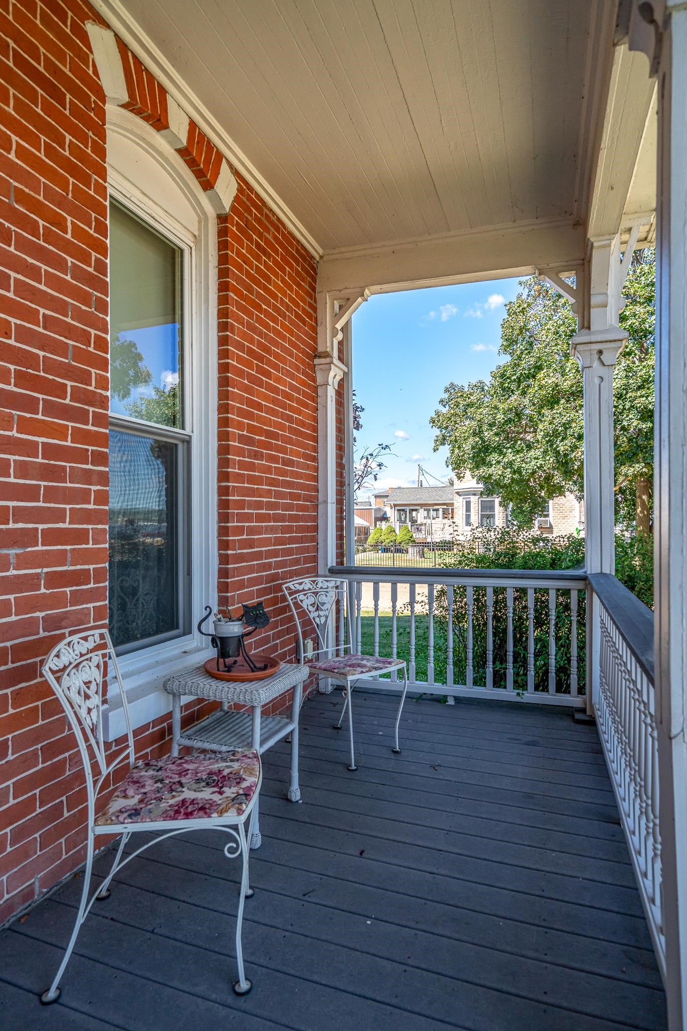 704 River Street Sabula, IA 52070 - Photo 4 of 33 a balcony with wooden floor table and chairs