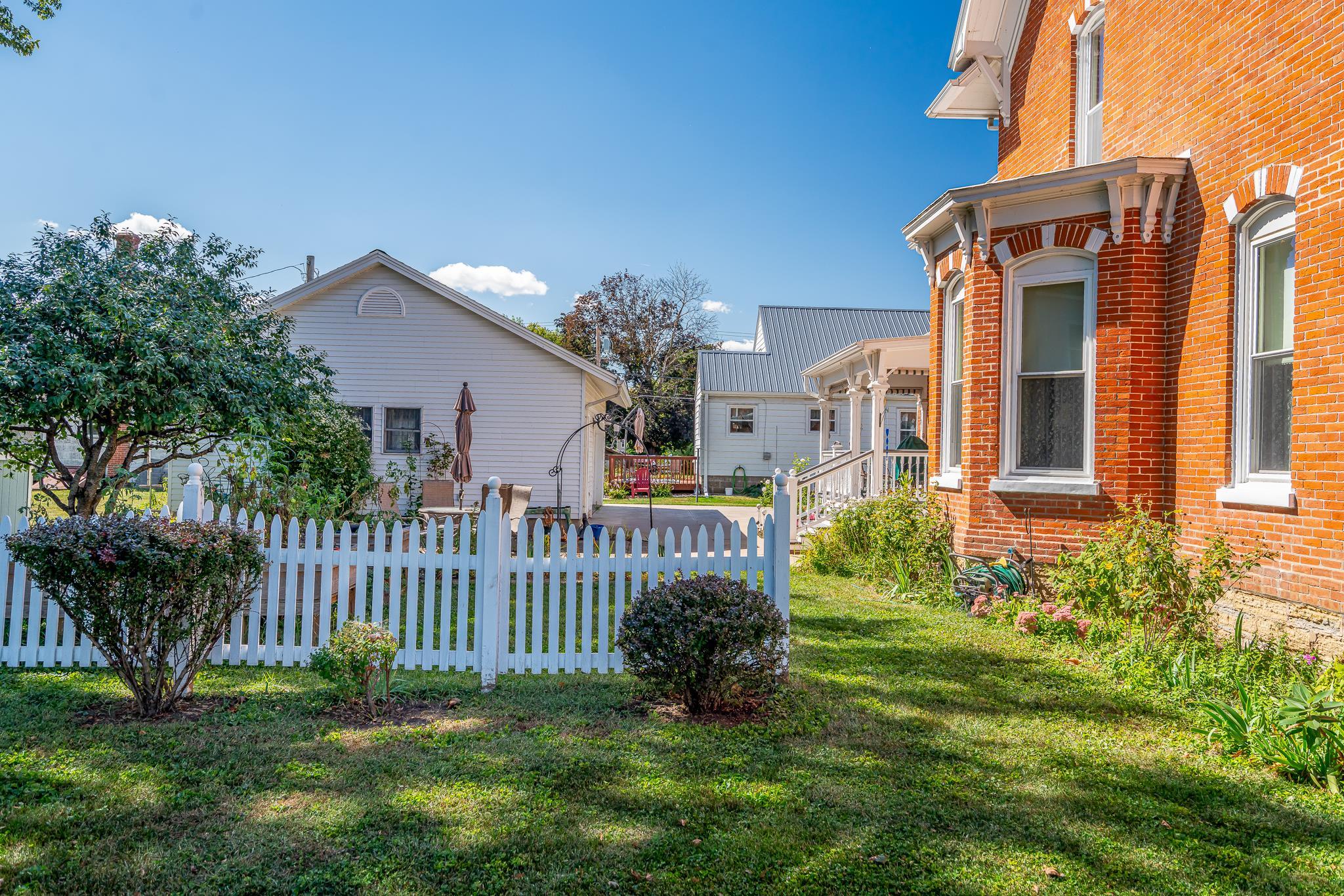 704 River Street Sabula, IA 52070 - Photo 5 of 33 a view of a house with brick walls and a yard with plants