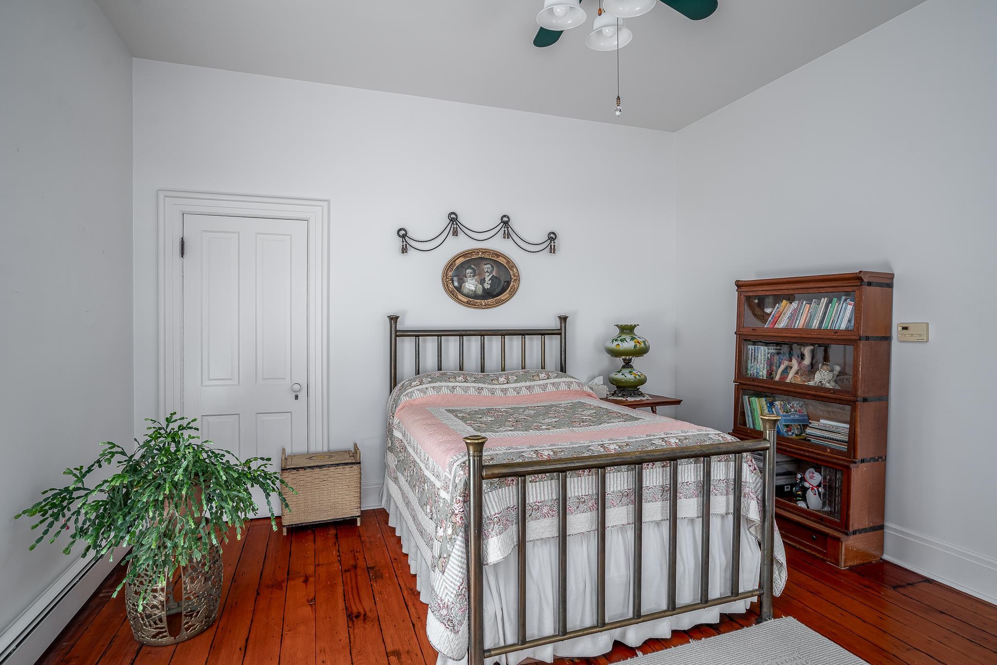 704 River Street Sabula, IA 52070 - Photo 10 of 33 a bedroom with a bed and a book shelf