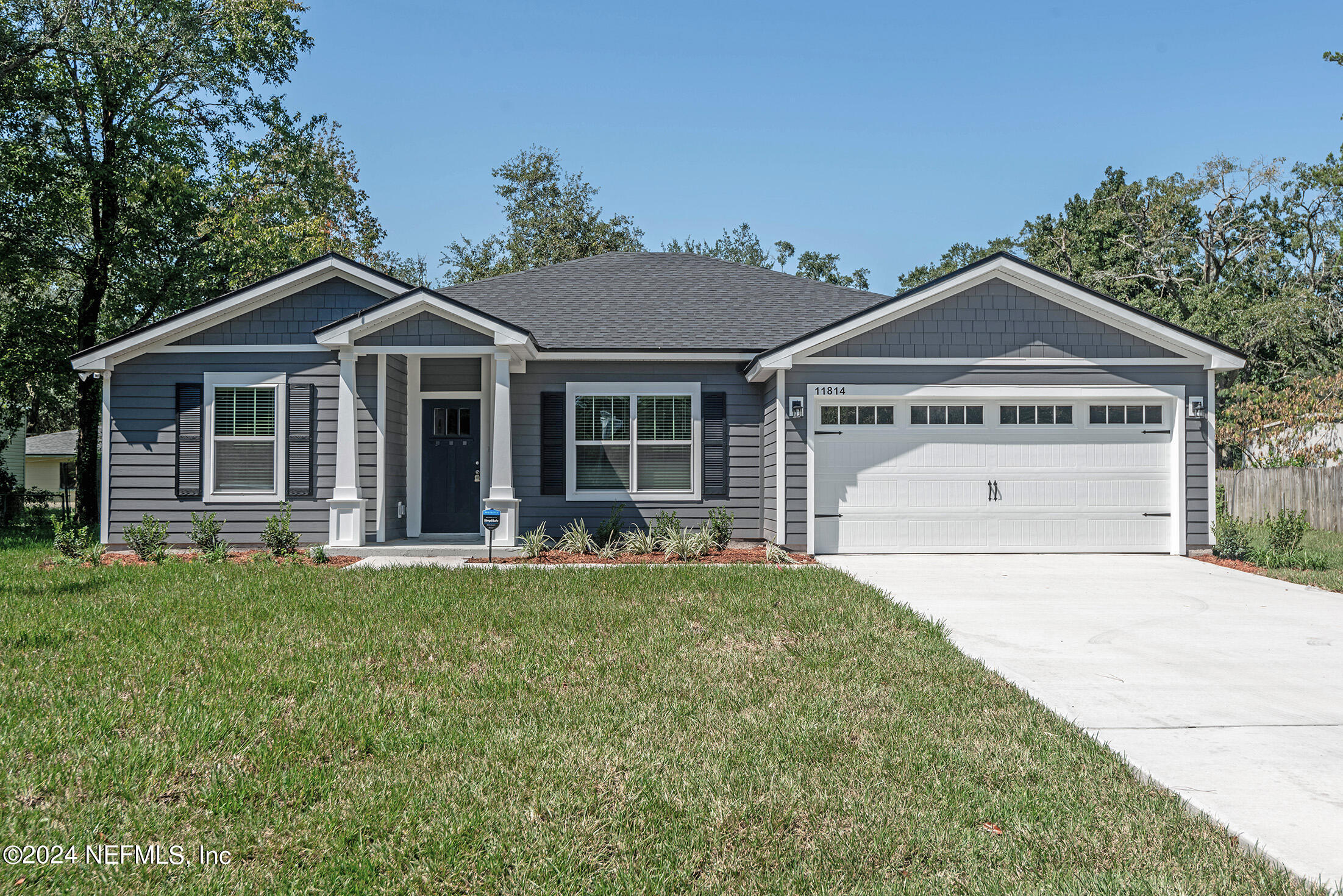 a front view of a house with a yard and porch