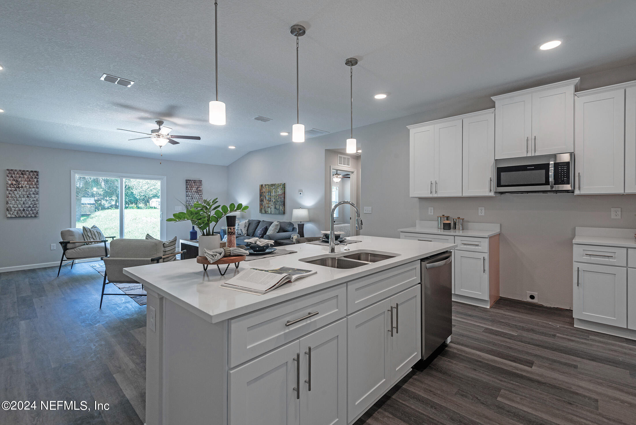 11814 Dunn Creek Road Jacksonville, FL 32218 - Photo 12 of 50 a kitchen with a sink stove and cabinets